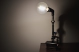 A small table lamp crafted from repurposed metal and wood.
