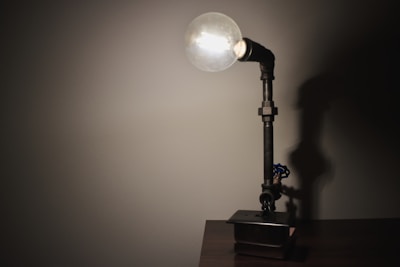 A small table lamp crafted from repurposed metal and wood.