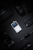 A collection of multimedia devices including headphones and speakers.