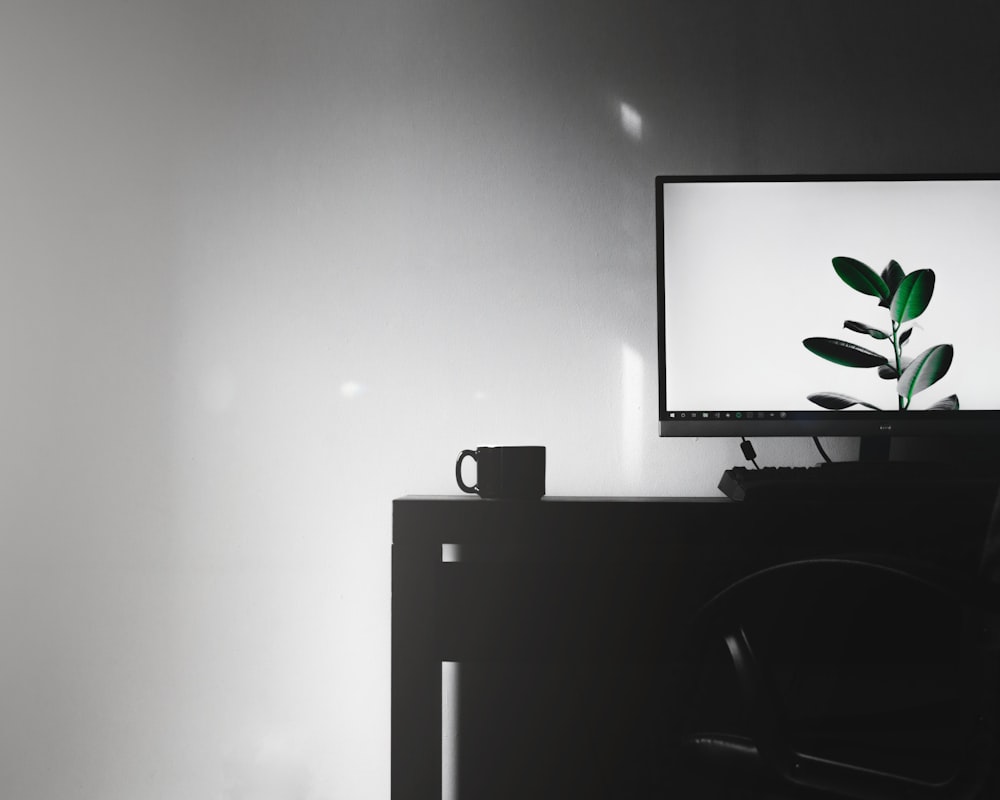 flat screen television on top of desk