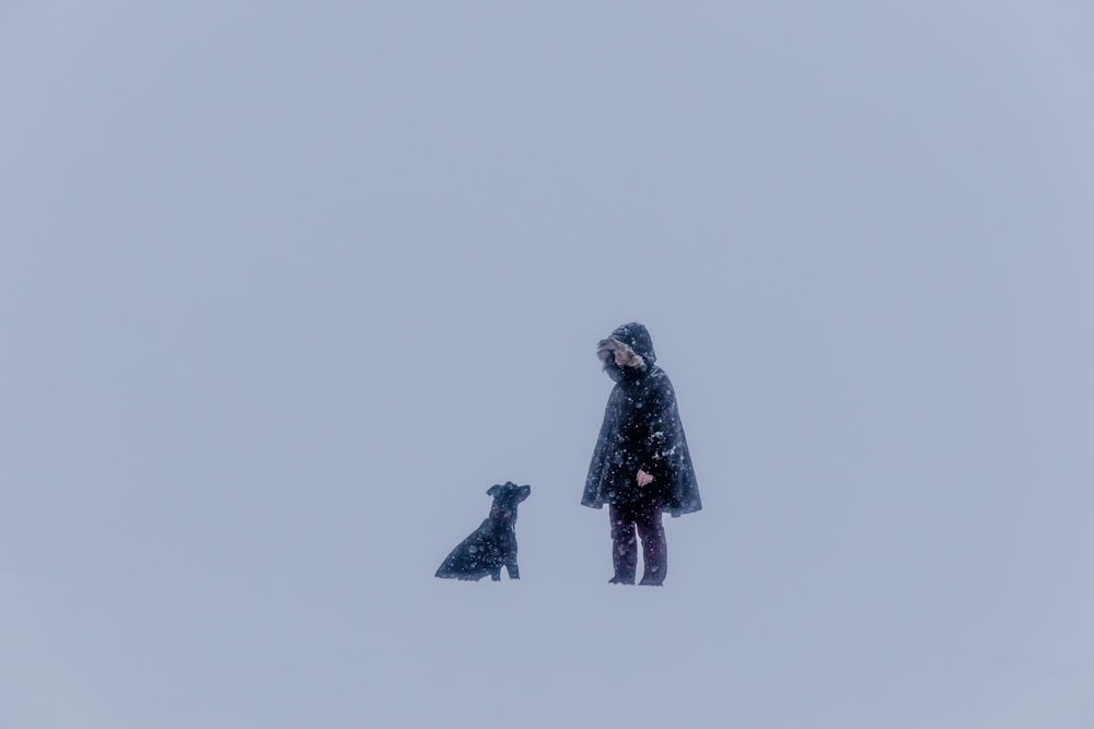 person beside black dog