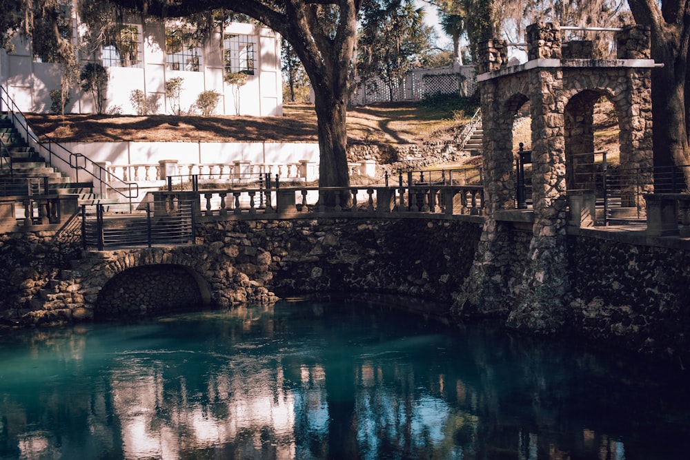 concrete bridge beside calm water