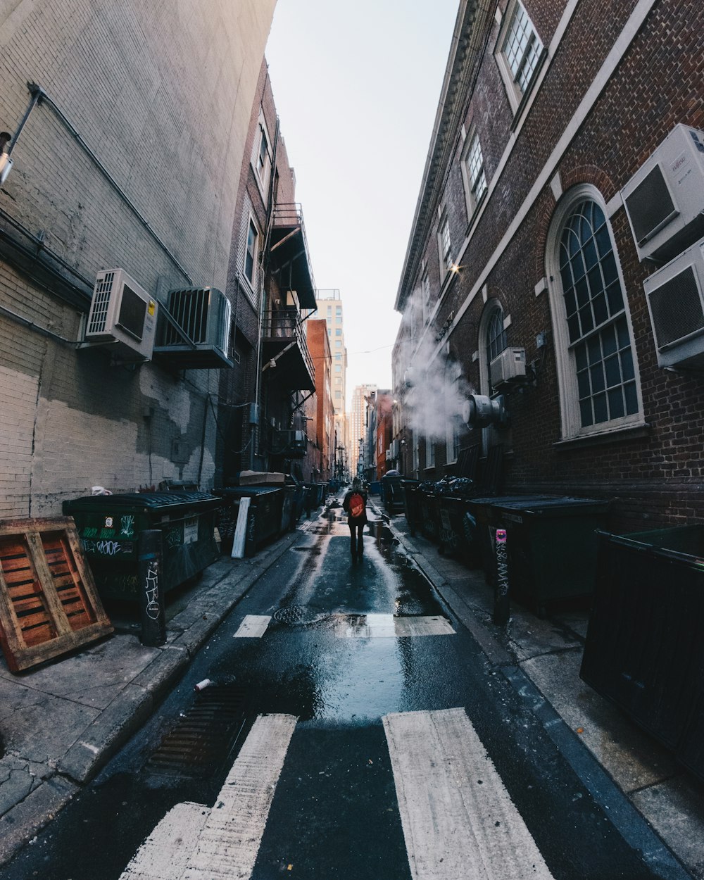 man walking along alley