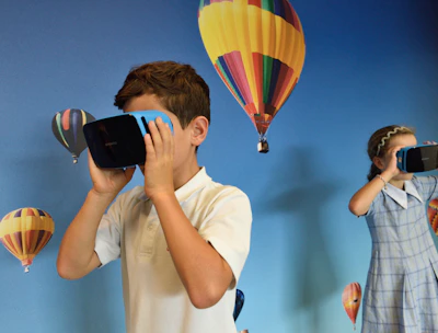 boy and girl uses VR goggles in front hot air balloons wallpaper