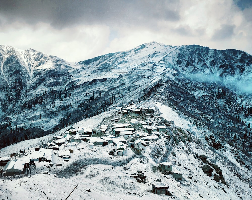 aerial photography of snow-covered village in mountain slope