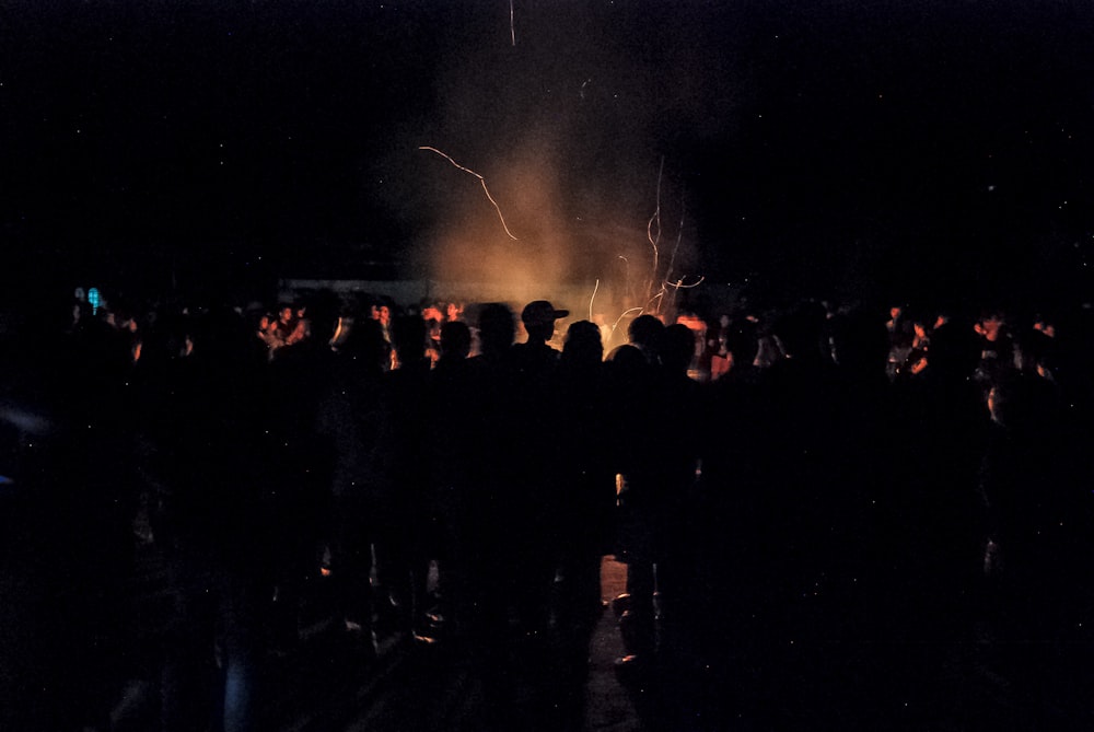 silhouette of crowd while watching fire