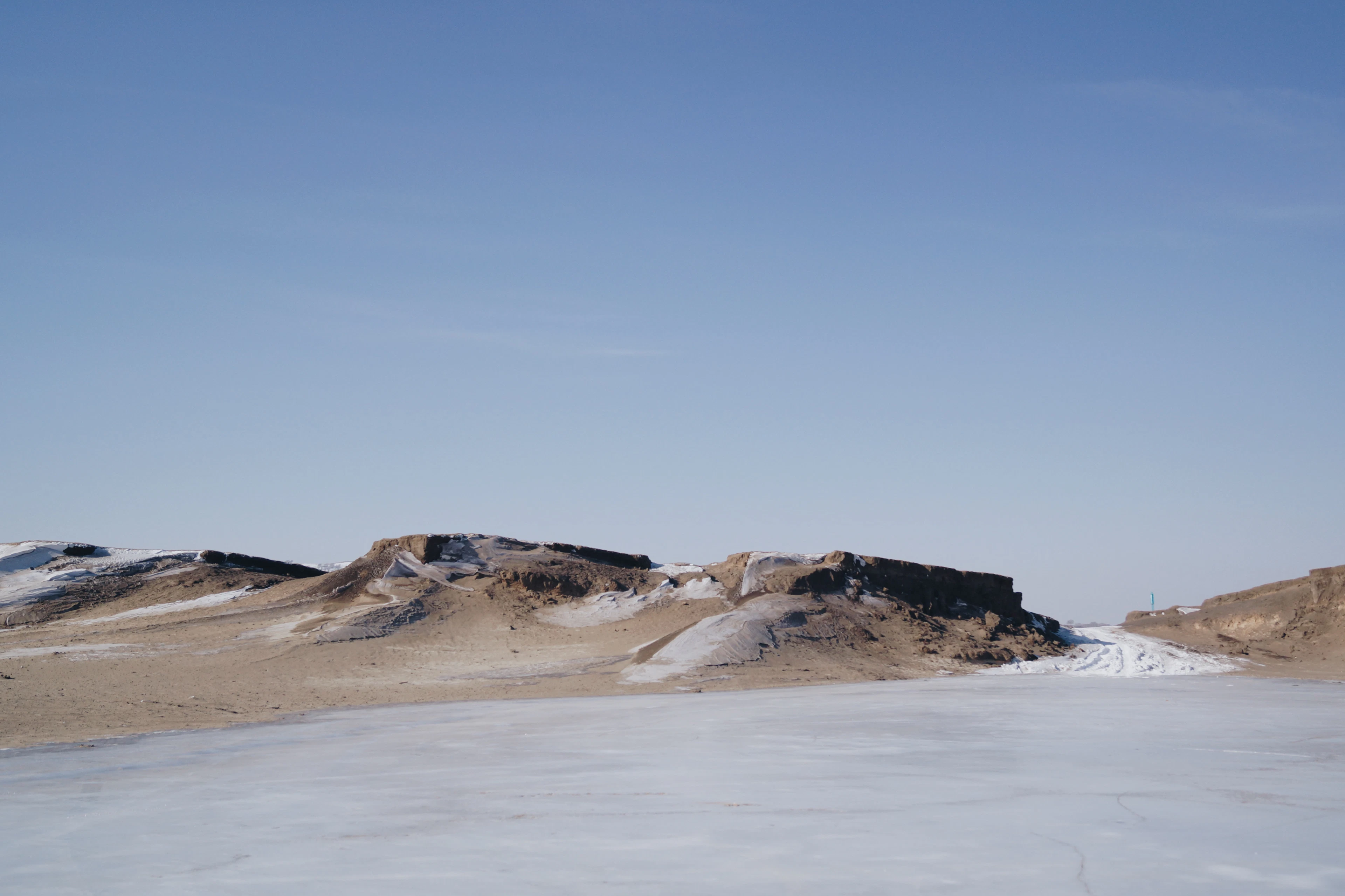 Wind-sculpted snow drifts on a winter plain