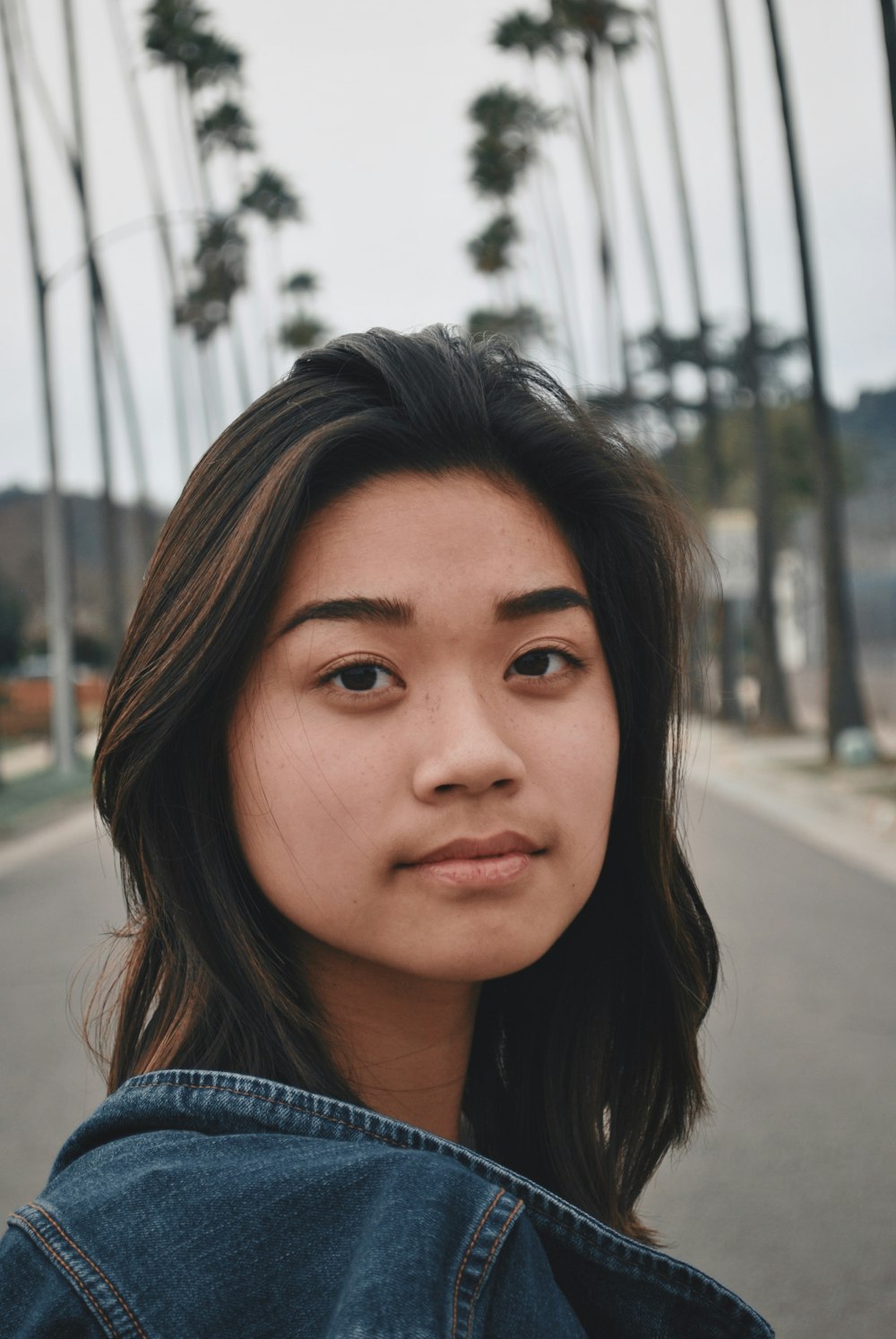 shallow focus photo of woman in blue denim jacket