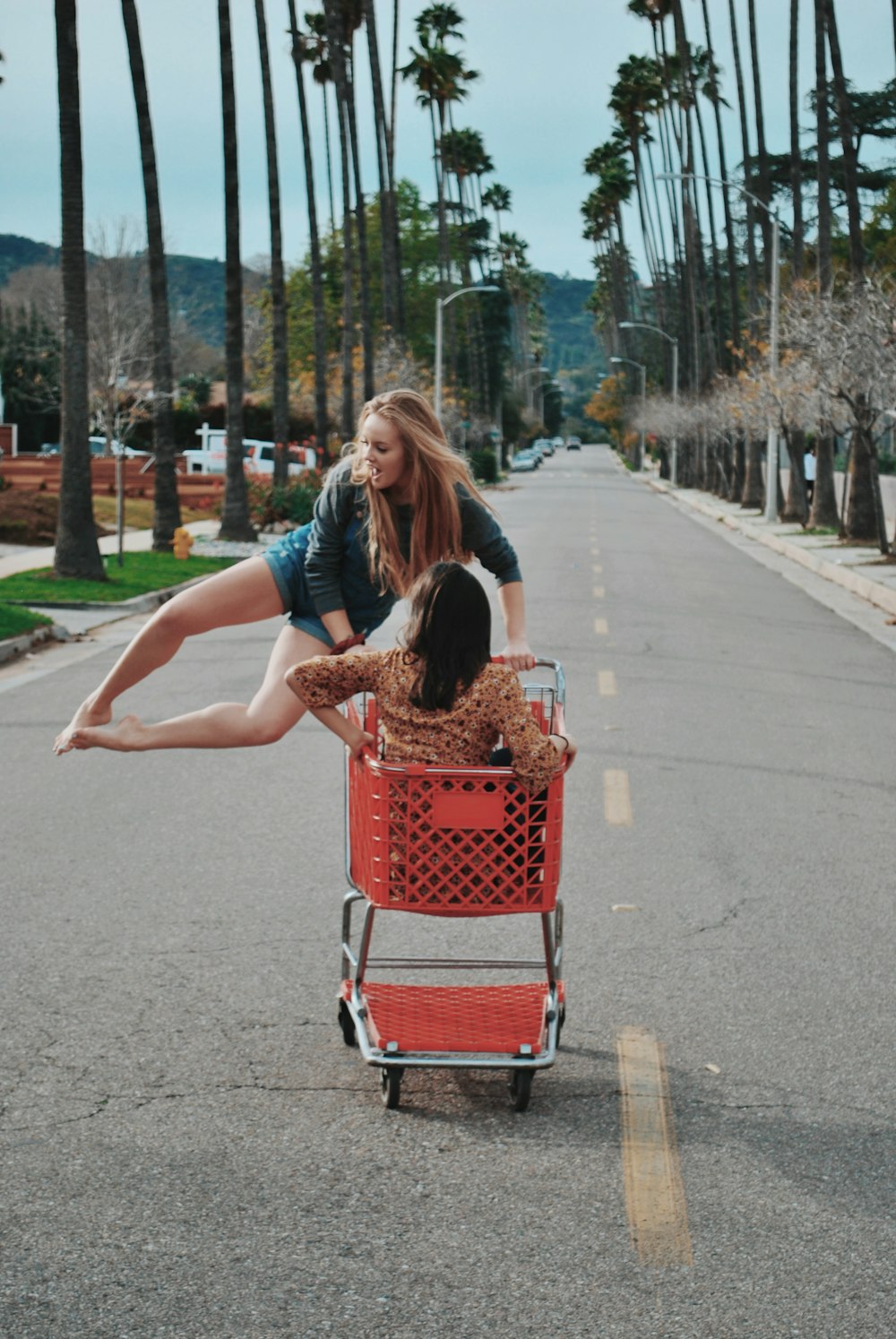 two women playing the shopping cart