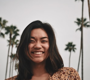 smiling woman wearing brown floral top
