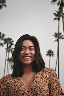 smiling woman wearing brown floral top