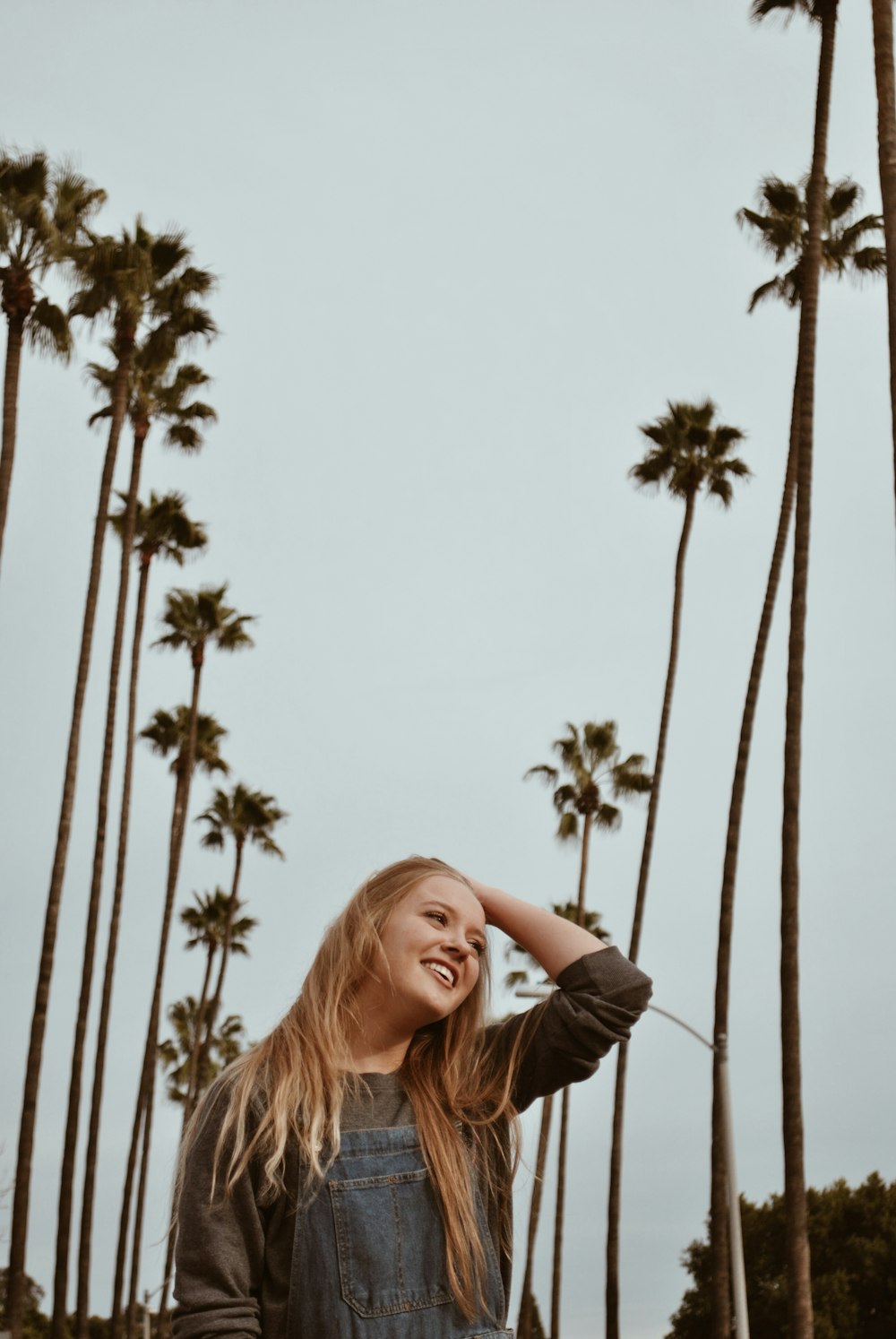 woman between coconut trees