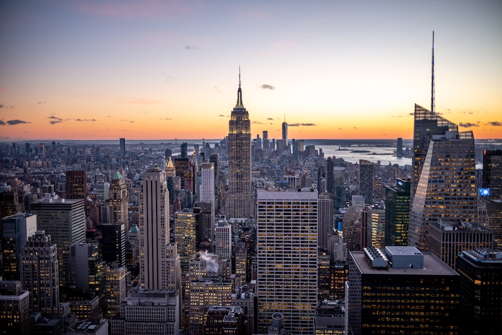 a view of a city at sunset from the top of a building