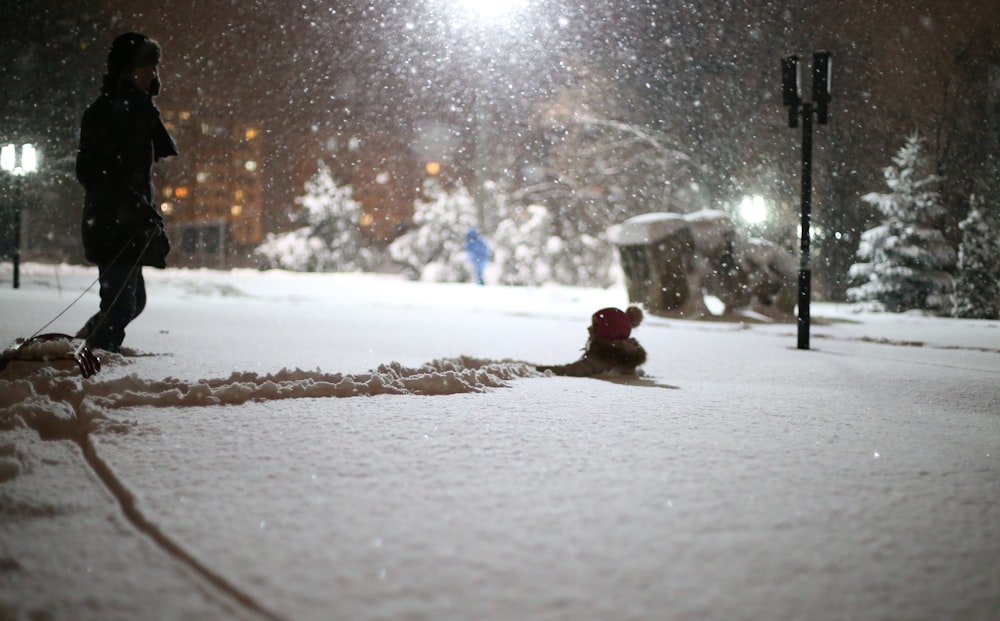 person standing on snow during nighttime