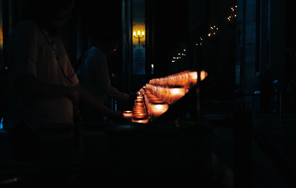 a row of lit candles sitting on top of a table