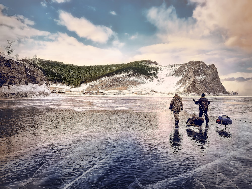 person walking near snow covered mountains