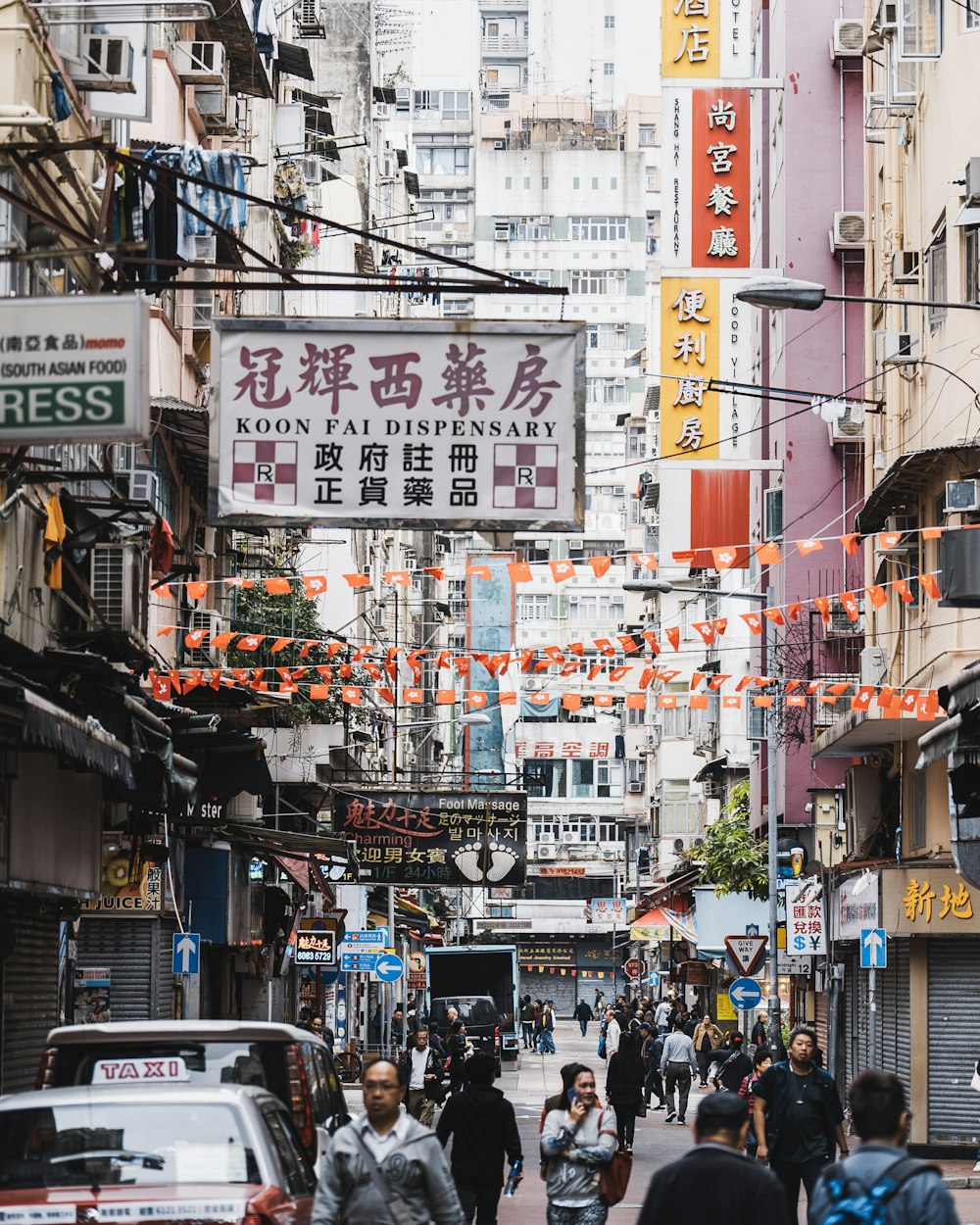 people walking on street in between buildings during daytime