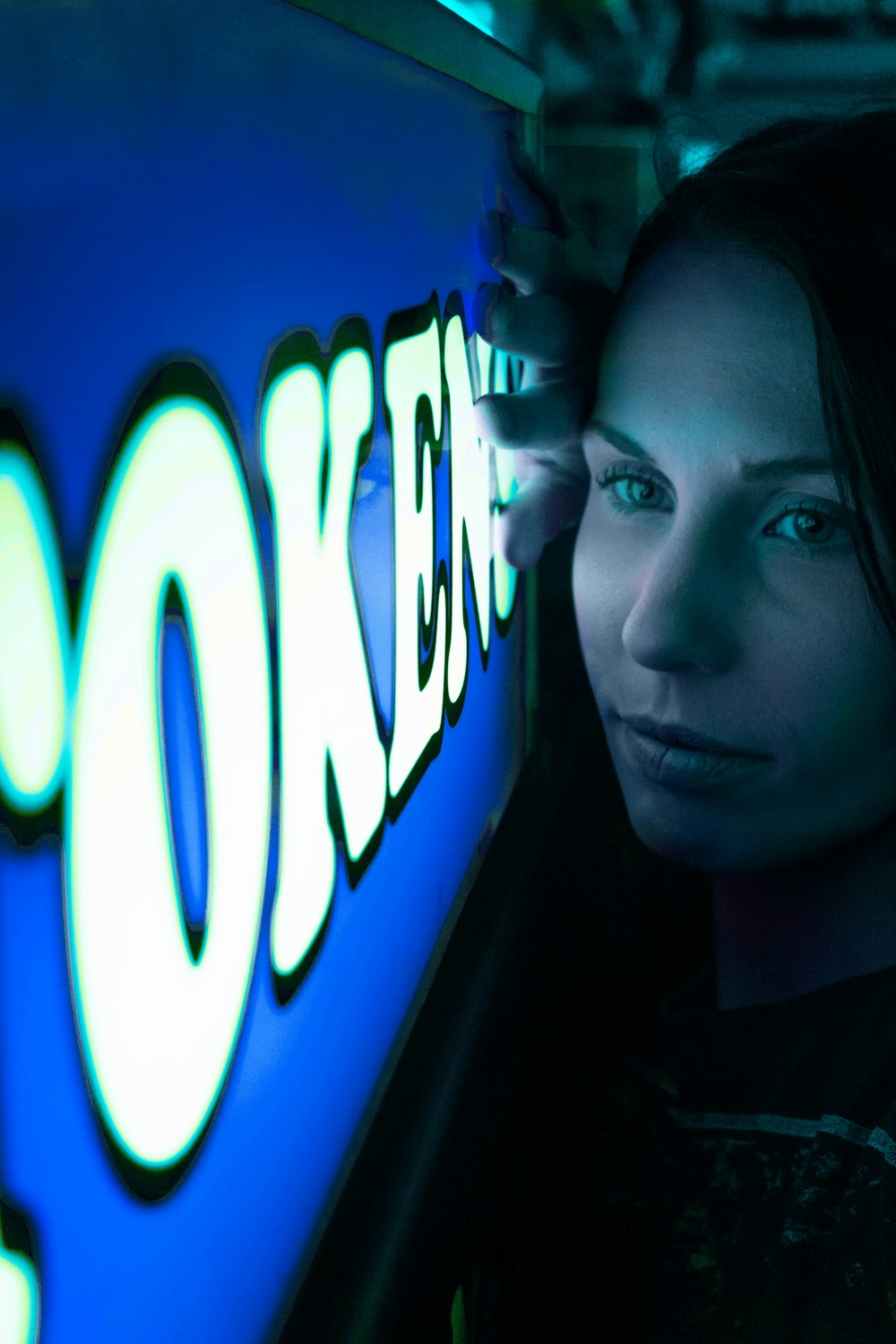 woman leaning on blue and white signage