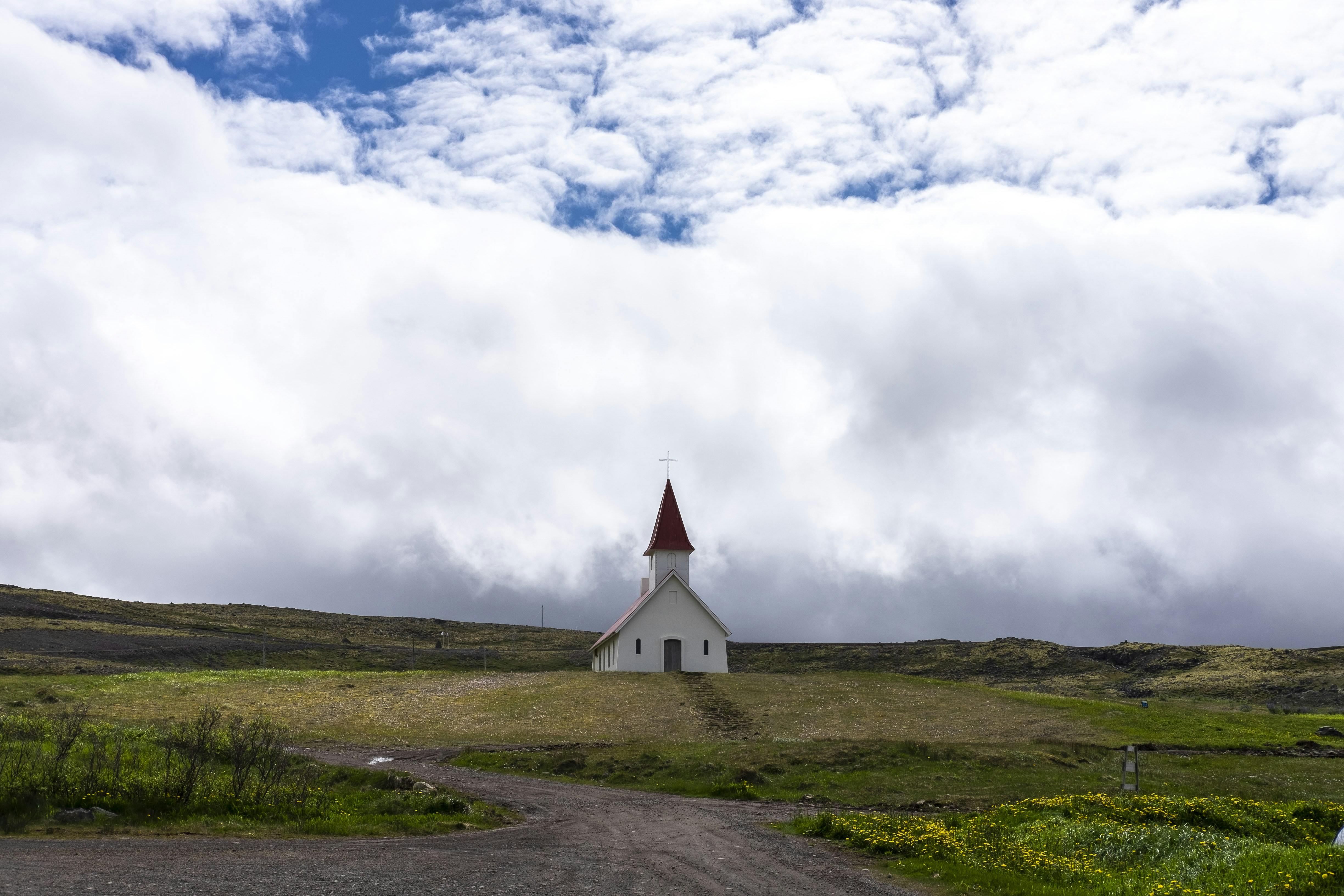 Iglesia sobre la hierba verde bajo el cielo nublado