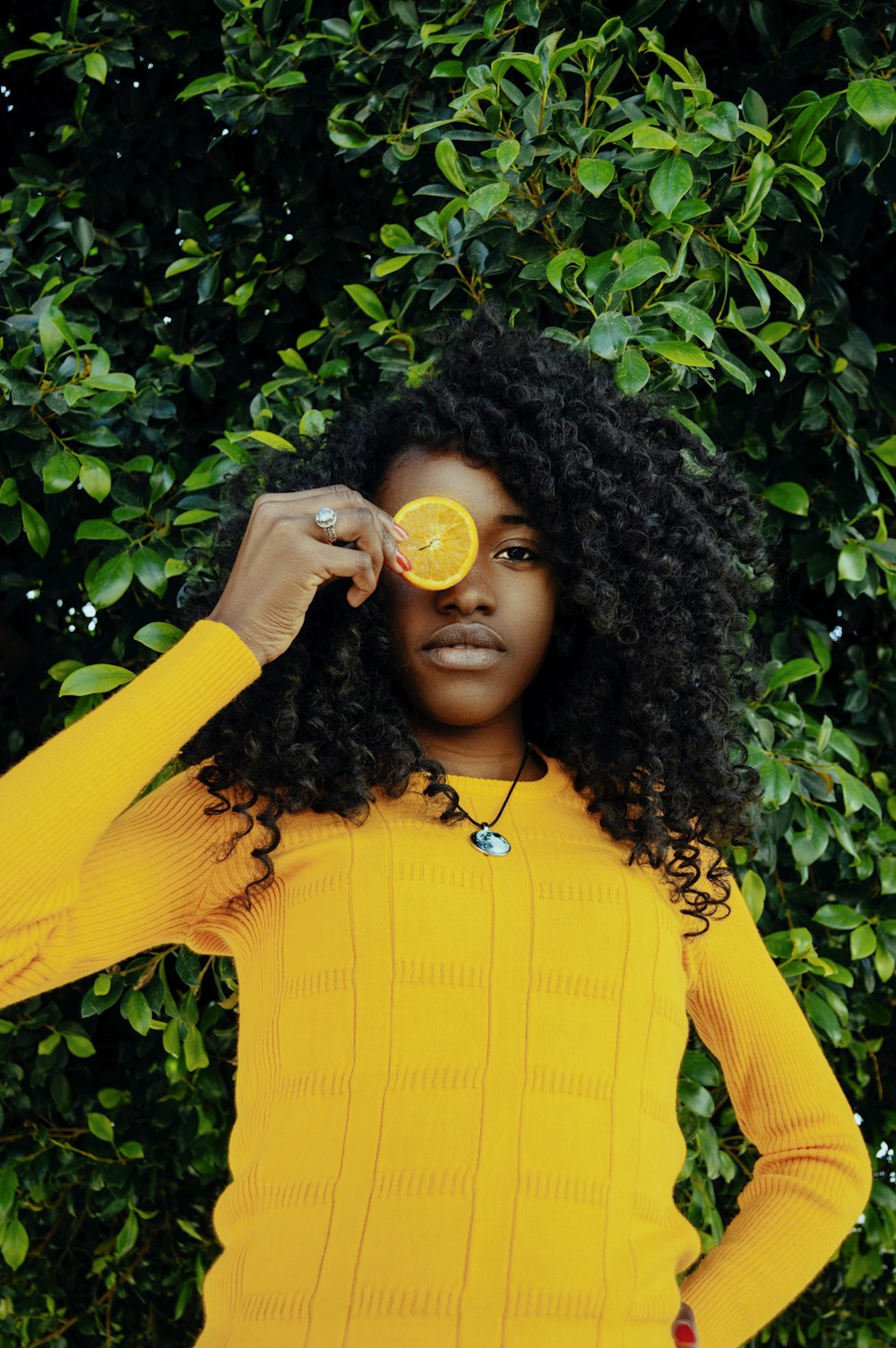 woman holding sliced lemon fruit