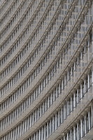 A detailed close-up of a modern building facade showcasing intricate architectural elements.