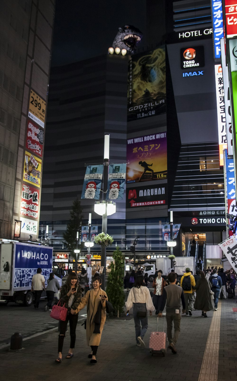 person's walking on street during night time