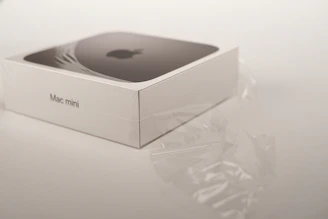 A futuristic 3D printed Mac Mini shell with geometric cutouts and a glossy finish.