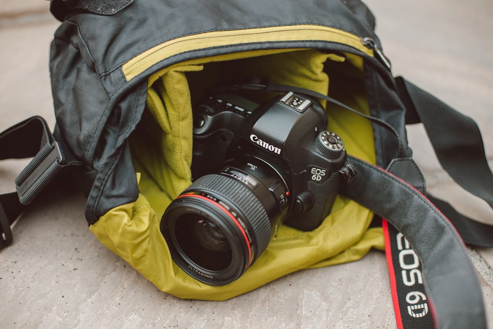 black Canon DSLR camera on bag