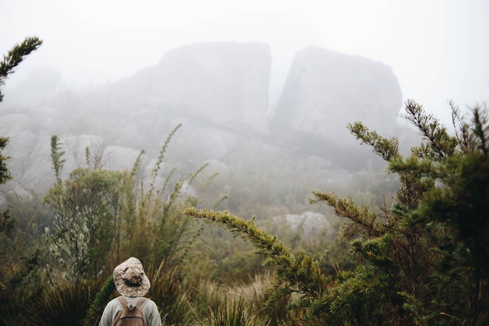 close-up photography of person standing near rocks