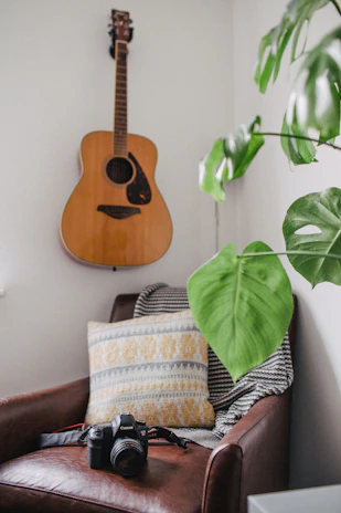 A cozy studio corner with warm chocolate brown and pale butter yellow accents, camera gear neatly arranged.