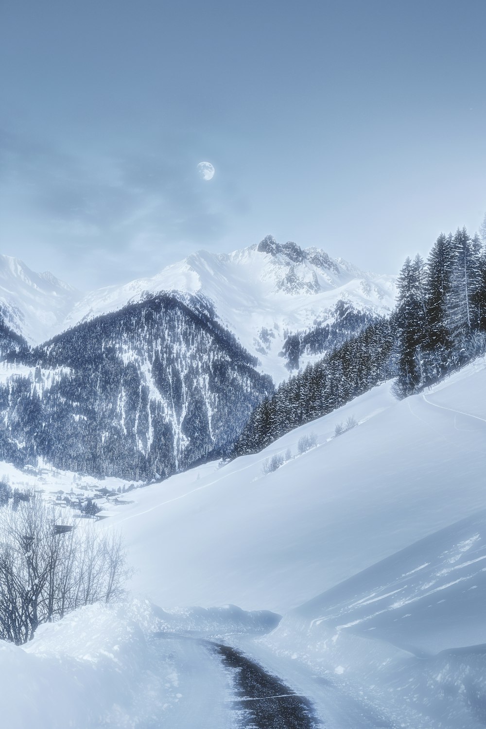 a snow covered mountain with a trail going through it