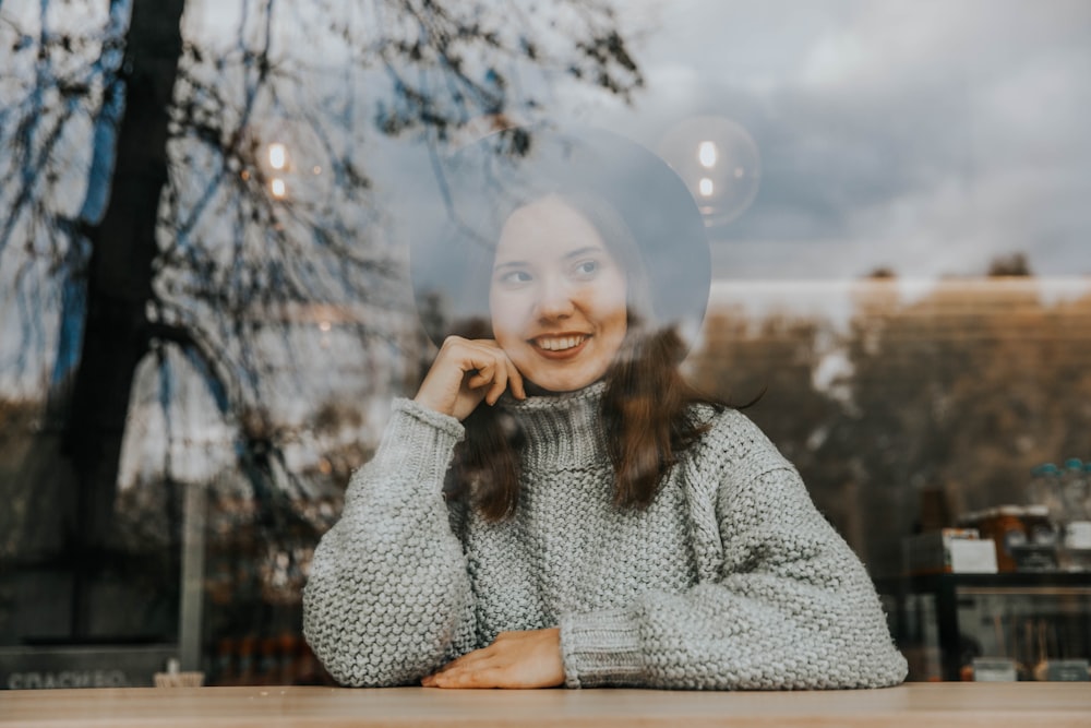 woman wearing gray sweater