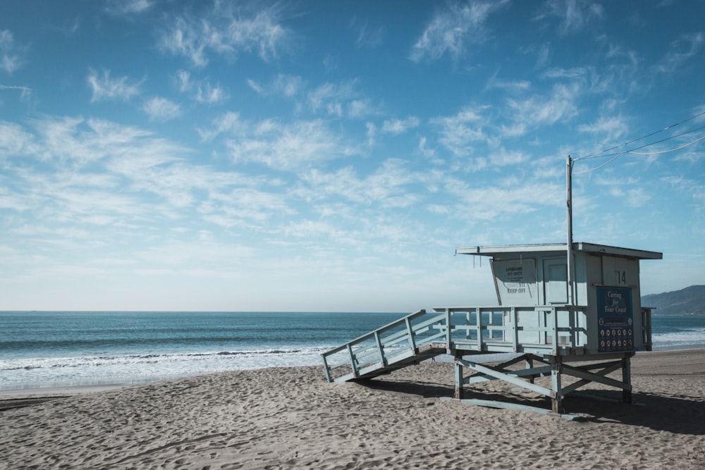 white lifeguard near body of water