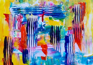 A vibrant abstract painting featuring a mix of bold colors and textures. Vertical stripes of black and blue are interspersed with areas of vividly applied paints in yellows, reds, blues, and greens. The brushstrokes are varied, with some areas showing smooth blends while others exhibit more defined lines and textures, suggestive of a dynamic and energetic composition.