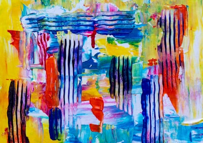 A vibrant abstract painting featuring a mix of bold colors and textures. Vertical stripes of black and blue are interspersed with areas of vividly applied paints in yellows, reds, blues, and greens. The brushstrokes are varied, with some areas showing smooth blends while others exhibit more defined lines and textures, suggestive of a dynamic and energetic composition.