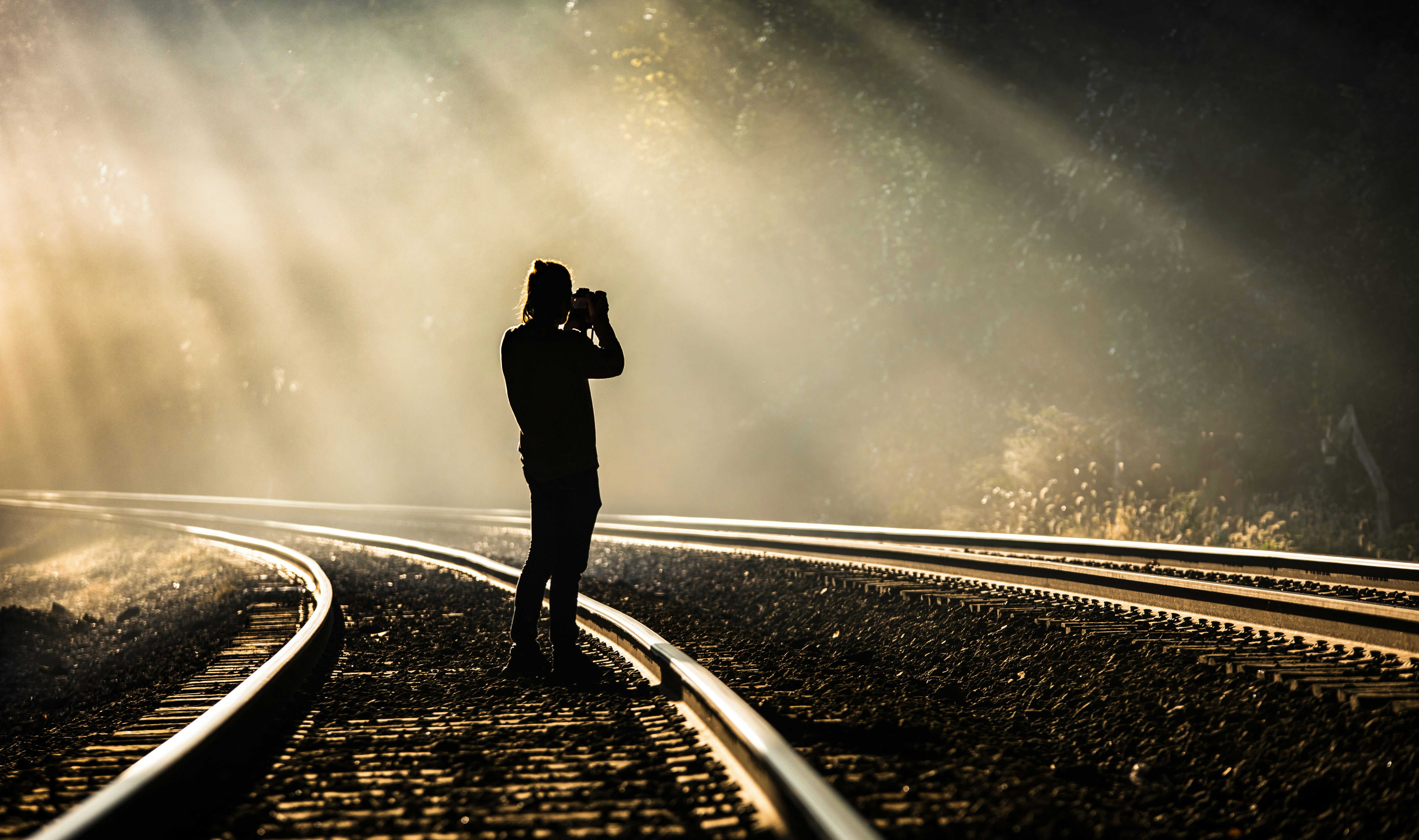 Person taking photo on train track