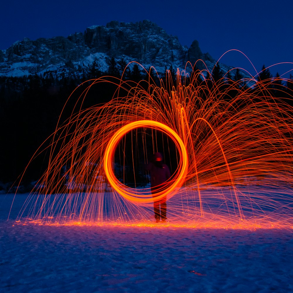 person holding red fire sparks