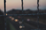 Close-up of security fence with integrated sensors at dusk