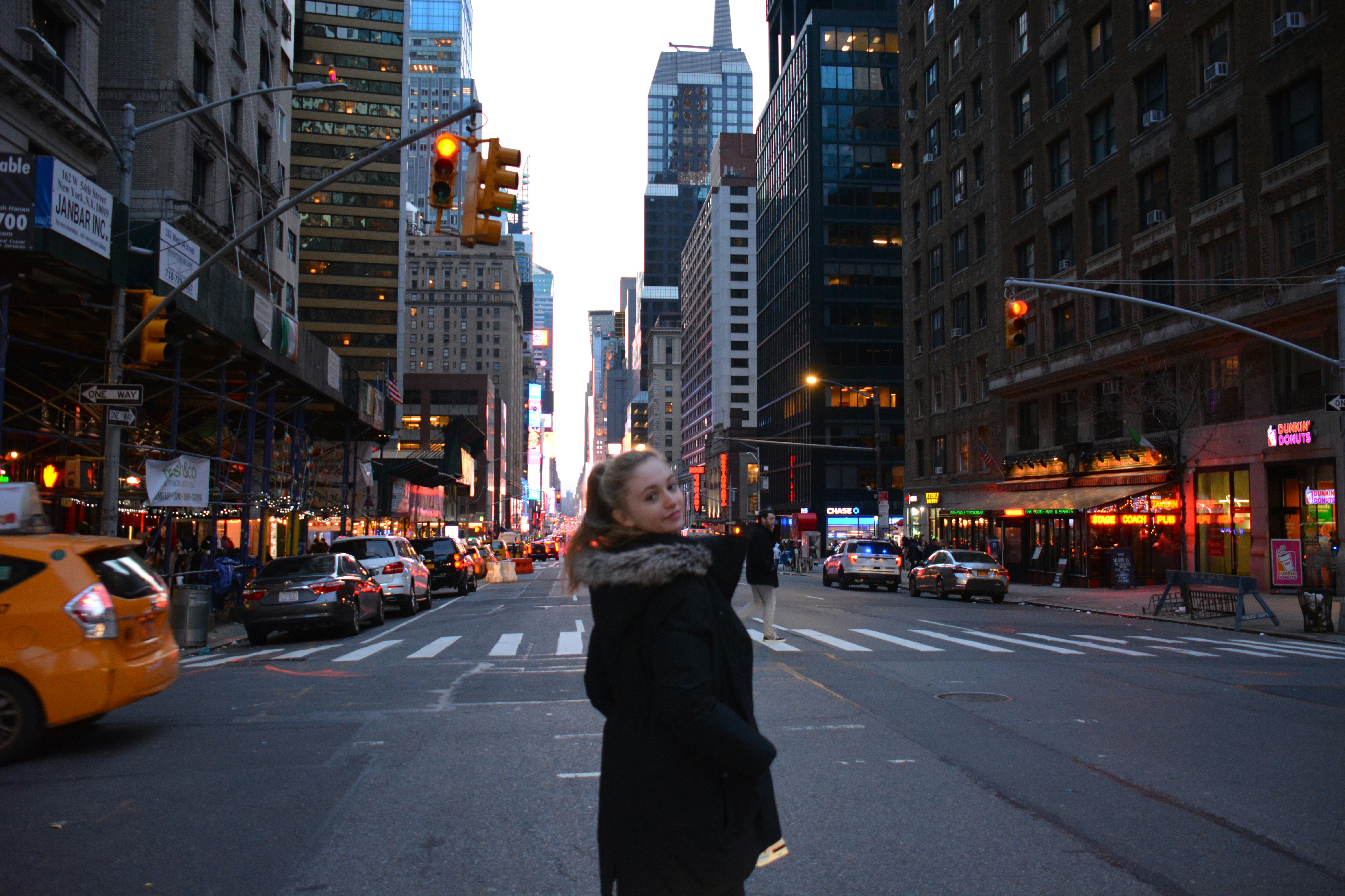 Fashion model in urban luxury outfit, bright city environment, well-lit modern street photography