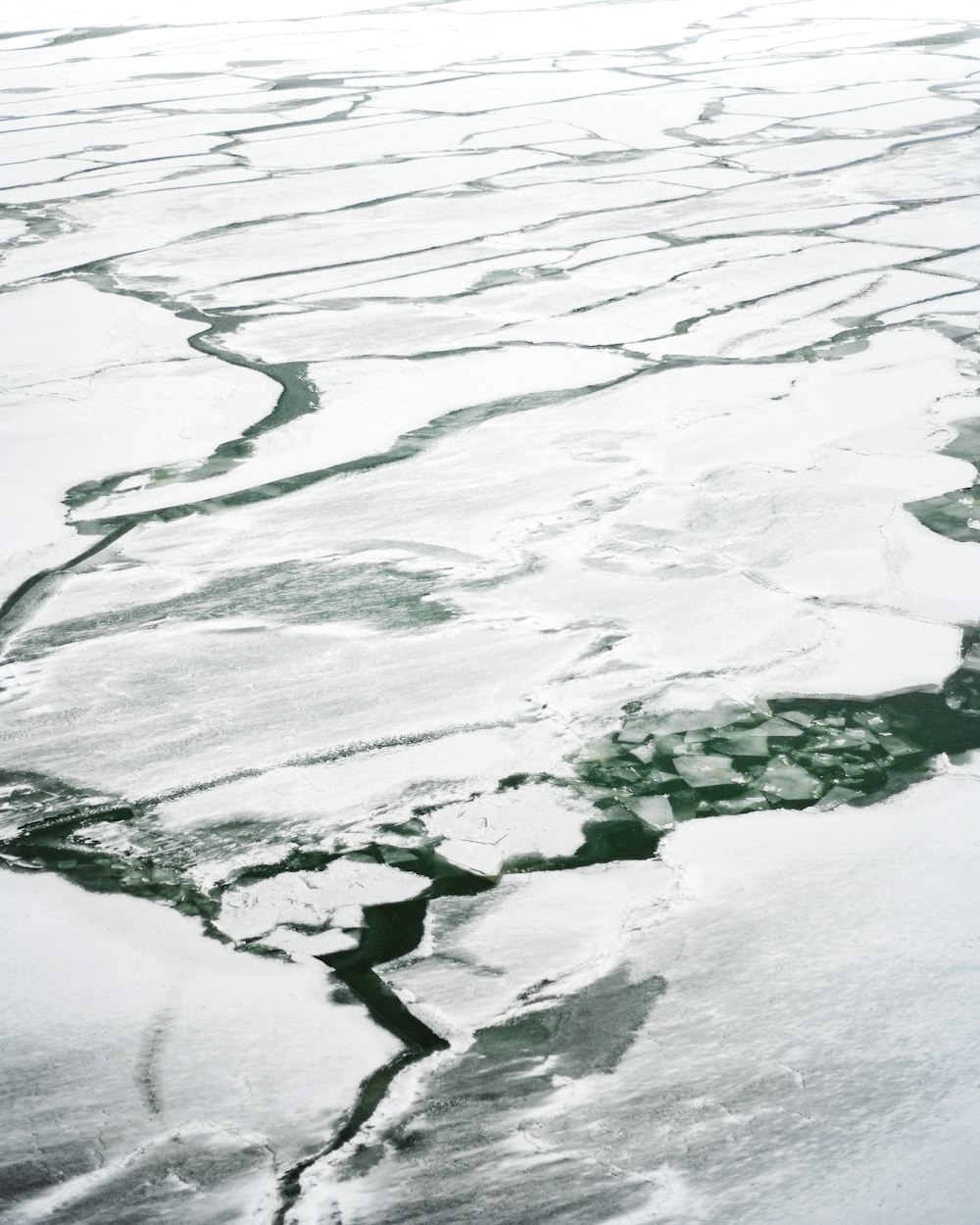 an aerial view of ice floes and water