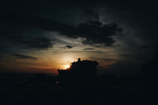 A breathtaking sunset over the Tanah Lot temple silhouette.