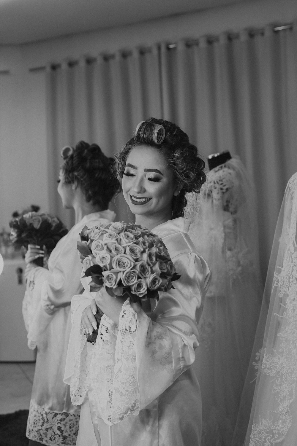 woman wearing bathrobe while holding bouqeut of flowers