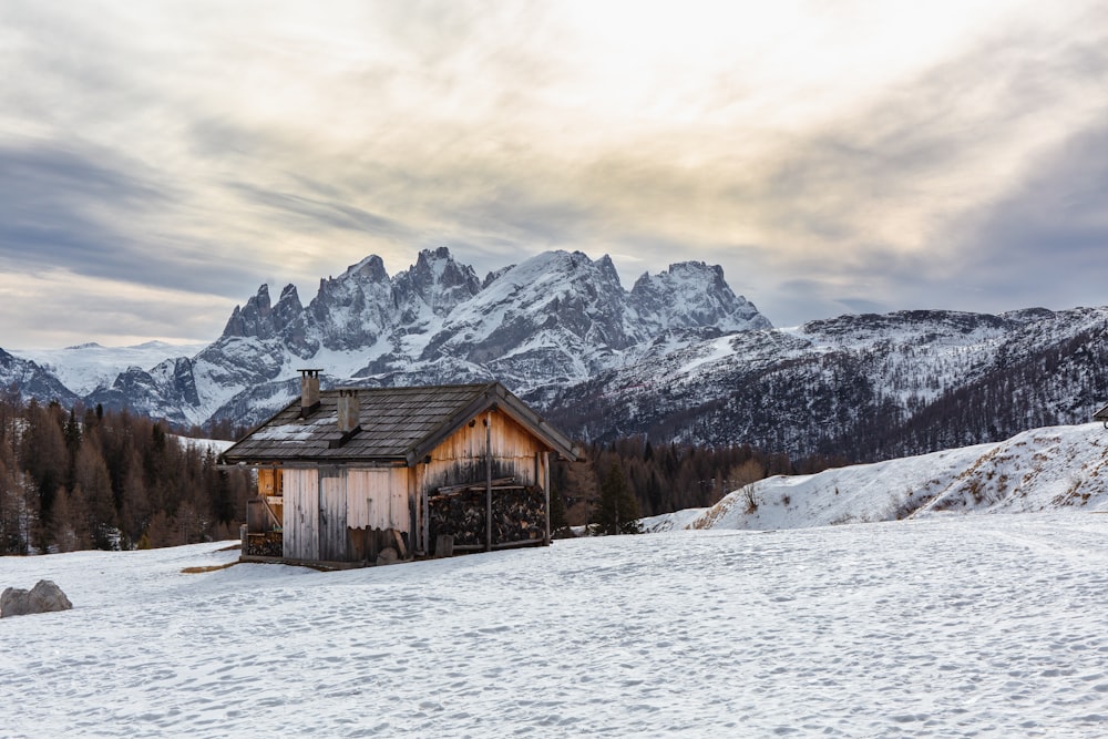 cabin near snow covered mountain