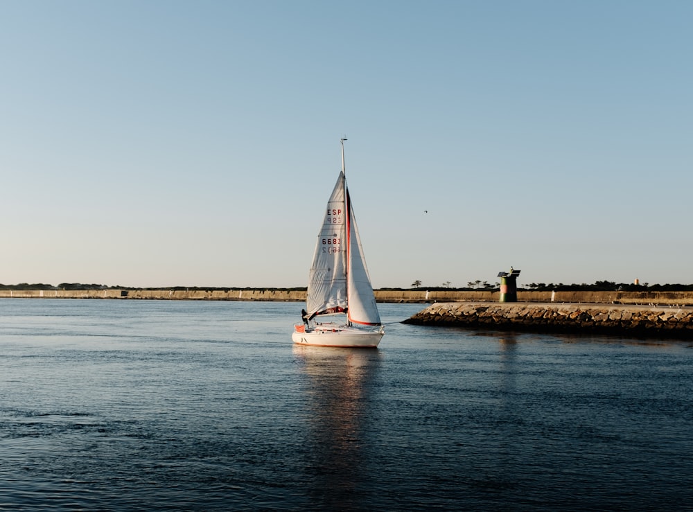 white sailboat near dock