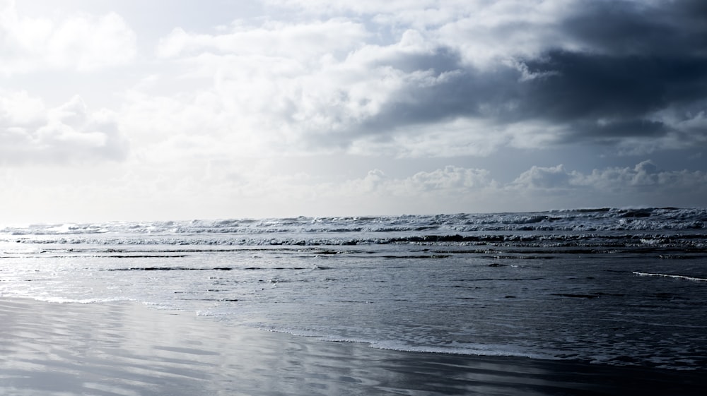 calm sea under cloudy sky