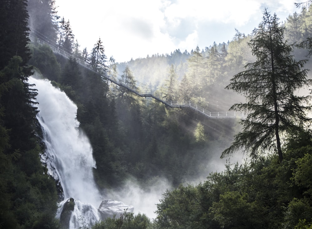 landscape photo of waterfalls near bridge during daytime