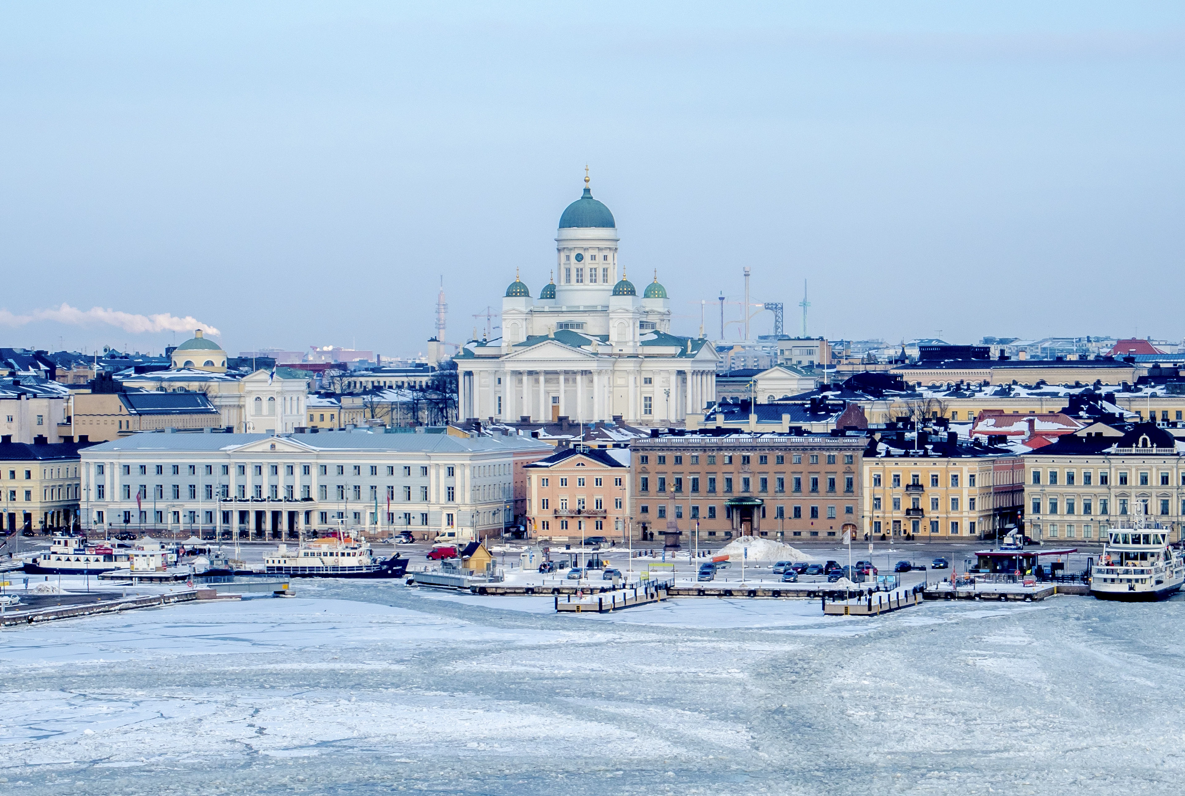 Helsinki Cathedral above the frozen harbour in winter, ice covering the water in the foreground