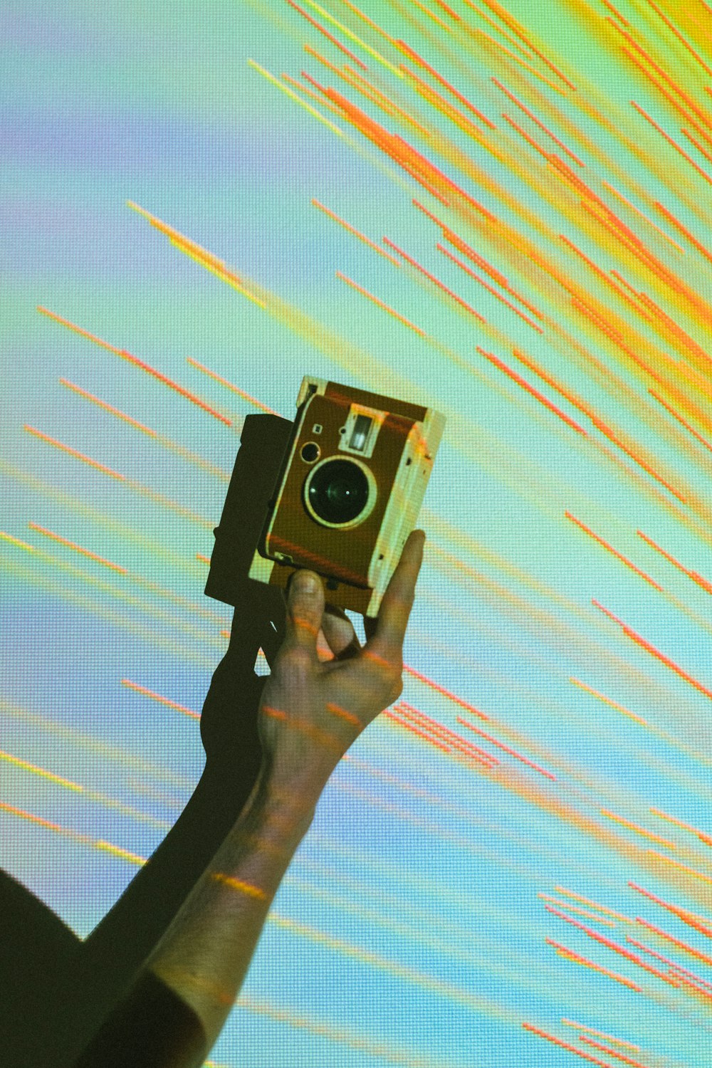 person showing brown and white vintage camera