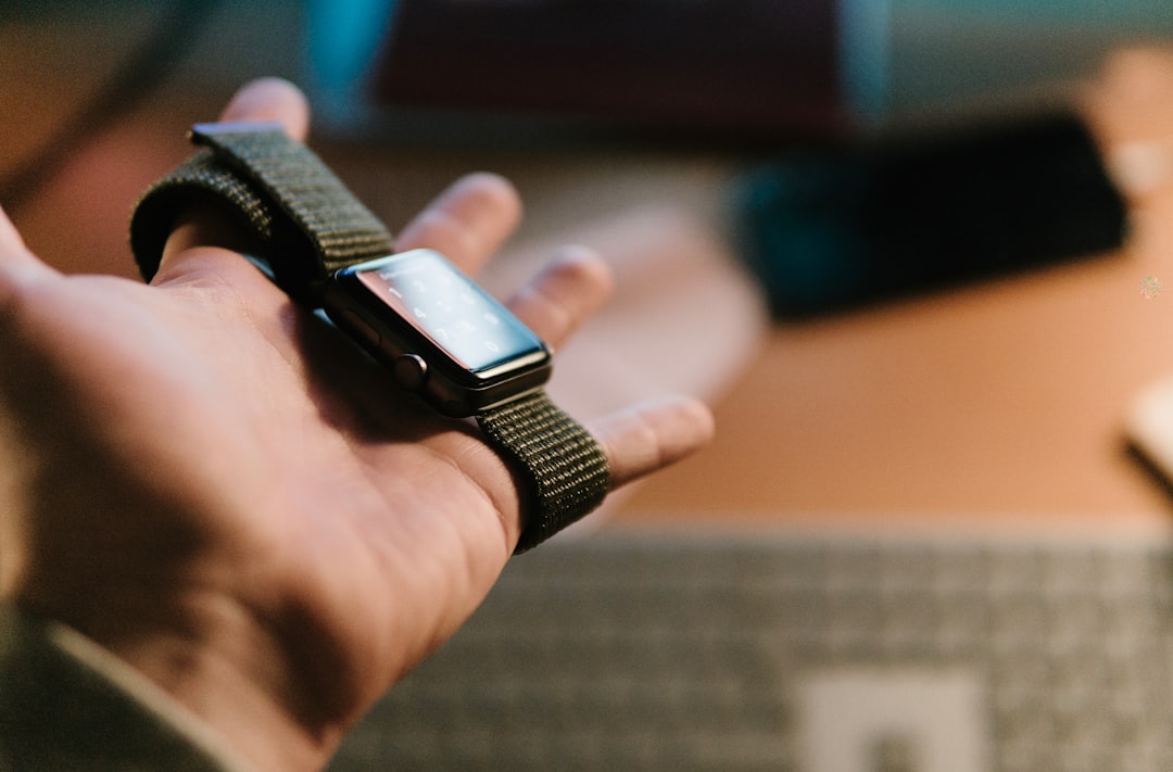 person holding Apple watch on selective focus photography