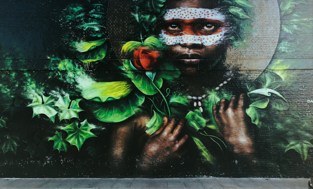 man with white and red face paint wall painting